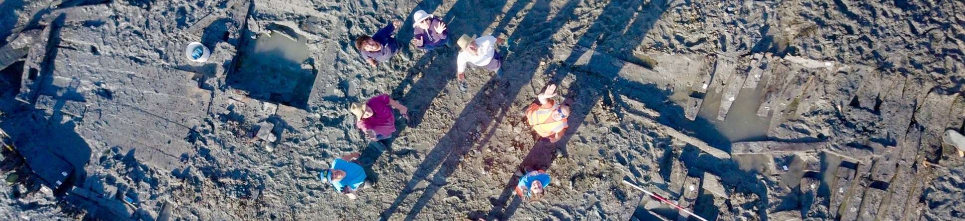 Aerial image of the early-18th century wreck of the Old Brig emerging from mud and sand of the Thames Estuary at Seasalter, north Kent.