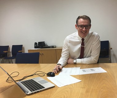 Man sitting at a table with a laptop