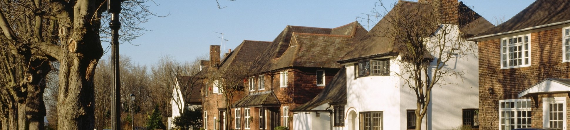 Sub-urban street lined with trees in Gidea Park conservation area, London Borough of Havering