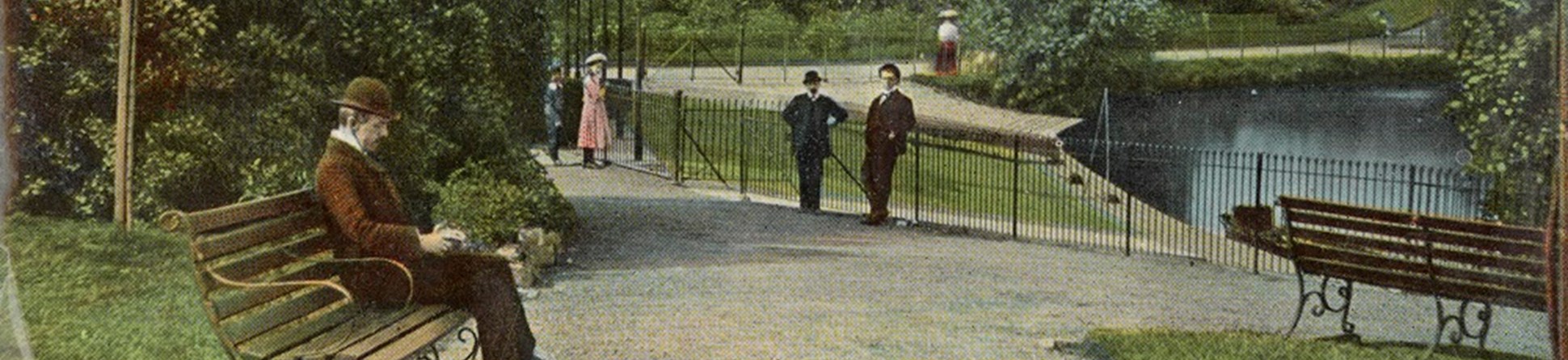 A Victorian chap is depicted sitting on a bench in a postcard of Handsworth Park that shows a general view of the boat house and pool