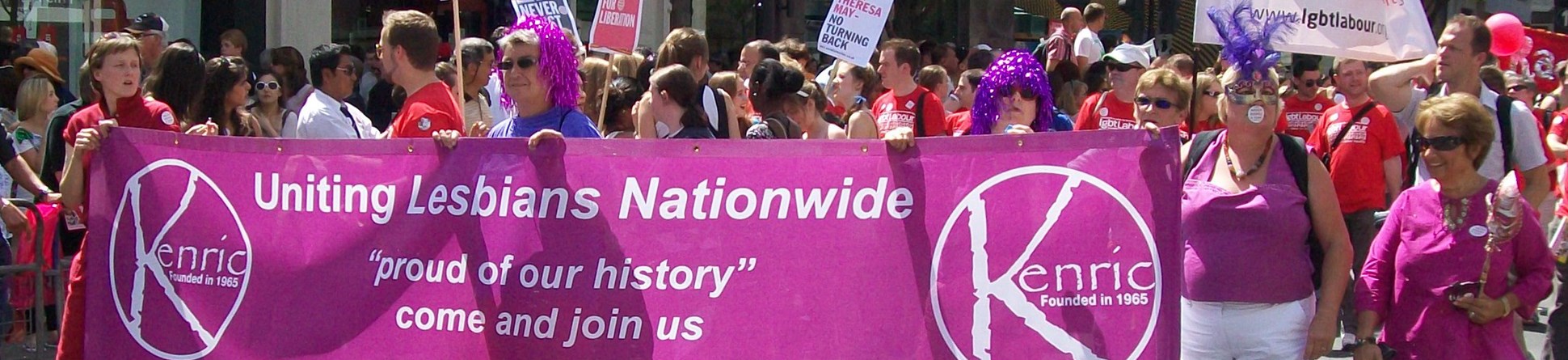 Marchers carrying Kenric banner with wording: 
Uniting Lesbians Nationwide
"proud of our history"
come and join us
www.kenric.org.uk