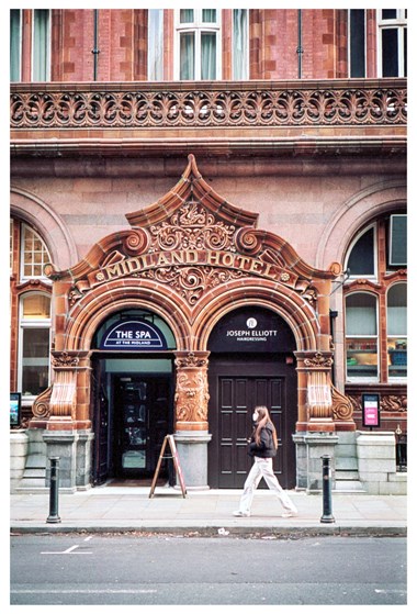 Exterior view showing the Mount Street entrance to the Midland Hotel with a girl walking passed