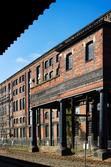 The Huddersfield warehouse (1885) with its external, hydraulically powered wagon hoist for taking wagons to the second floor of the building.