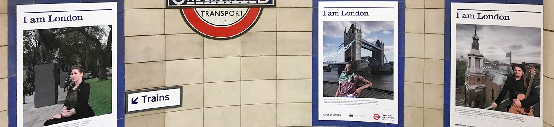 Three portraits from Historic England's I am London series displayed at Algate East Underground Station