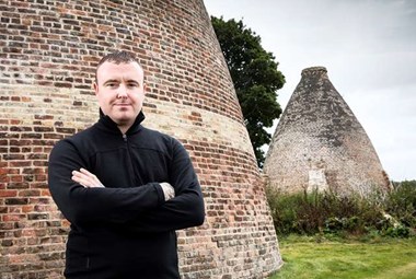 Kenny Brunskill standing in front of a bottle kiln