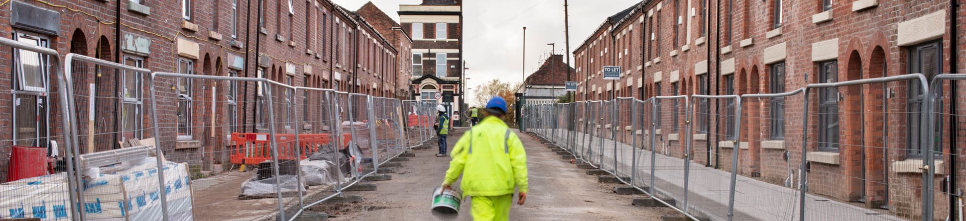 Workers restoring traditional terraced housing.