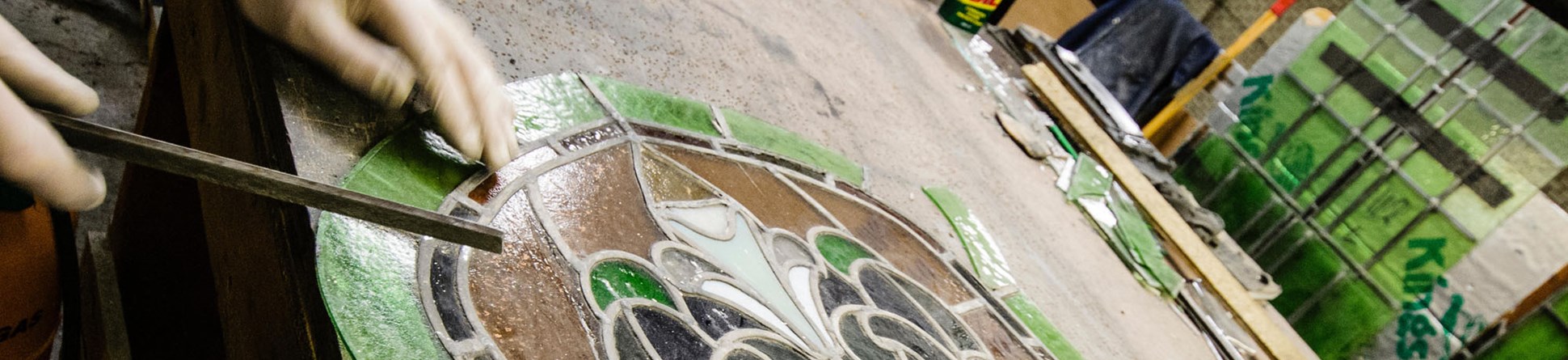 Stained glass window on a work bench undergoing restoration.