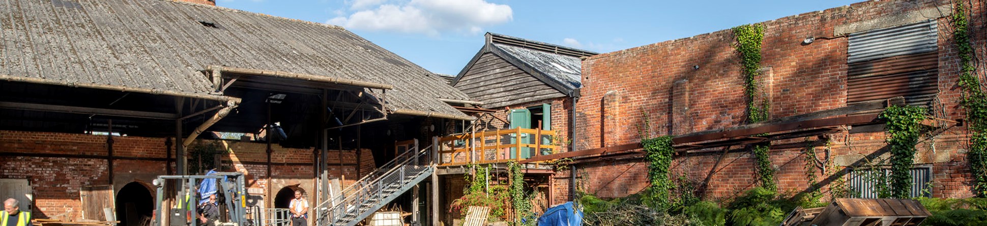 View of decaying asbestos roof above kilns and derelict brick drying shed.