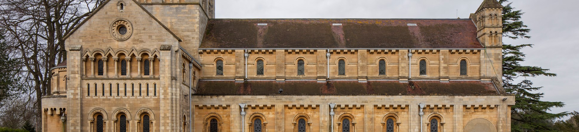 The side view of the Minster Church of St Benet in Beccles shows the grand scale of the church, with its tower, gabled roof and three storey nave.